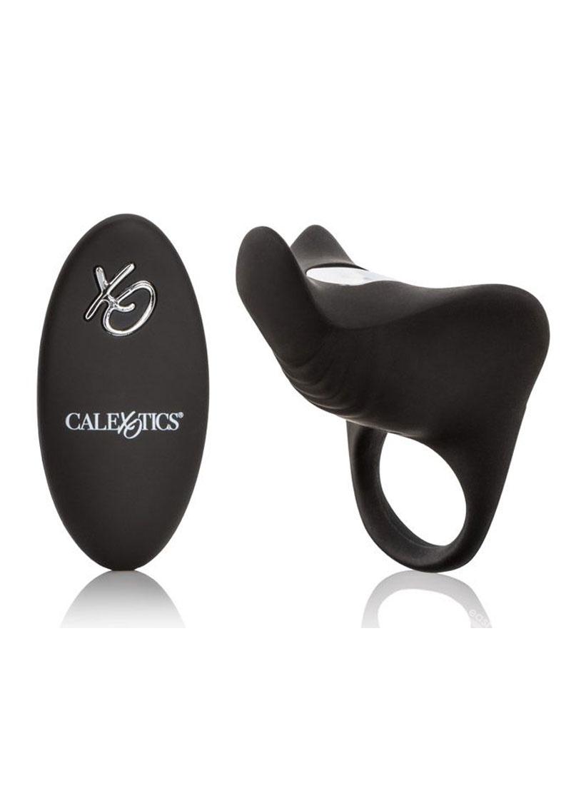 A black silicone couples vibrator ring with a remote control. The ring is sleek and has a smooth finish, while the remote is oval-shaped with a prominent brand logo.