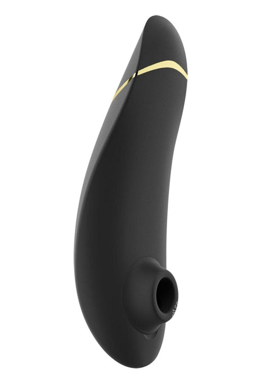 A sleek, black silicone clitoral stimulator with a gold accent near the base. The product has a smooth, curved design and a small opening at the front for sucking stimulation.